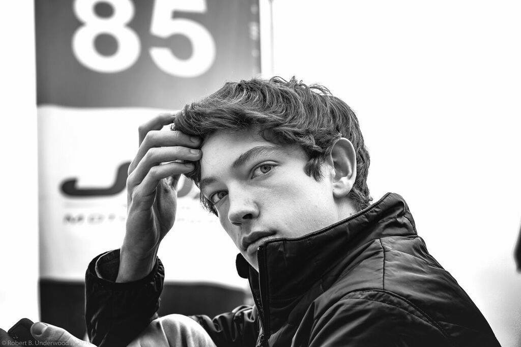 Kyle in the paddock, black and white, car number 85 behind
