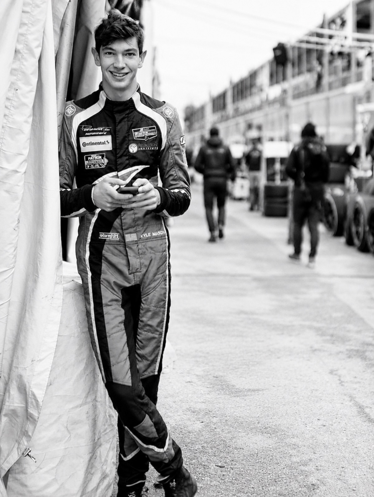 Kyle in his race suit in the pit lane, black and white